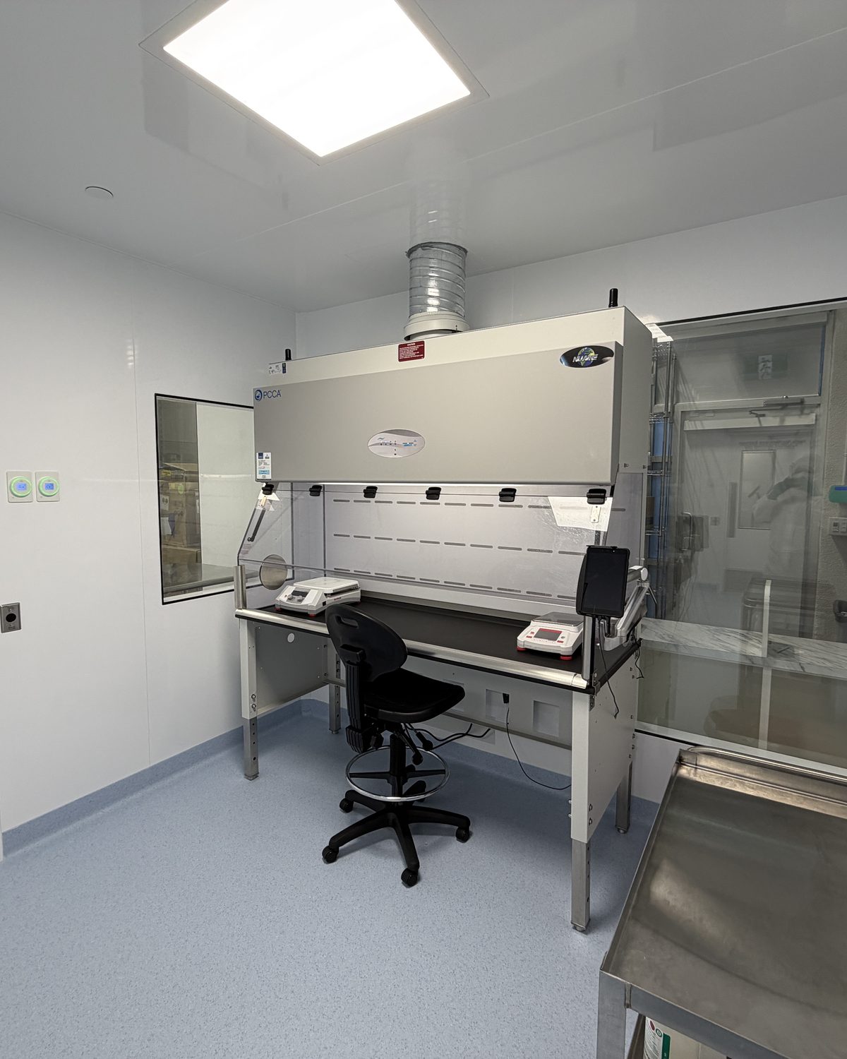 Containment ventilated enclosure installed in a sterile hazardous compounding cleanroom